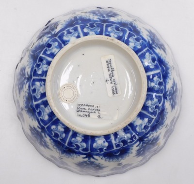 A Kangxi early 18thC blue and white Chinese porcelain bowl, of fluted form, decorated with flowers and Buddhist emblems within cloud borders, internally with flowers, impressed Manifest Happy mark, 19cm wide. (AF) - 3