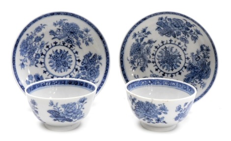 A pair of 18thC blue and white tea bowls and saucers, decorated with sprays, flowers and Buddhist emblems. (AF)