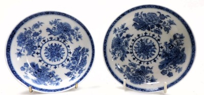 A pair of 18thC blue and white tea bowls and saucers, decorated with sprays, flowers and Buddhist emblems. (AF) - 2