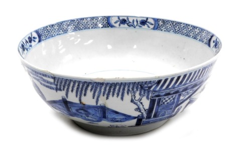 A Chinese Kangxi blue and white porcelain bowl, decorated with figures in a garden, internally with a gentleman beneath a border of reserved flowers and hatched banding, scrolls and scribe's implements mark, 29cm wide. (AF)