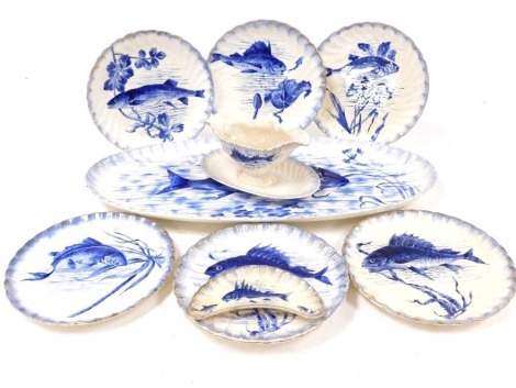 A late 19thC Royal Bonn blue and white pottery part fish service, painted with fish, comprising oval fish platter, sauce boat on integral stand, seven plates and a crescent shaped dish.