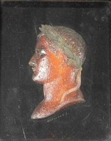 An early 19thC wax profile bust portrait of the Emperor Napoleon I, signed indistinctly, framed and glazed, 16cm x 12.5cm.