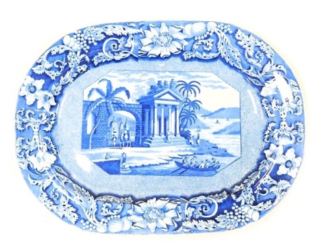 An early 19thC blue and white pottery meat platter, decorated in the Palladian Porch pattern, within a floral border, 42cm wide.