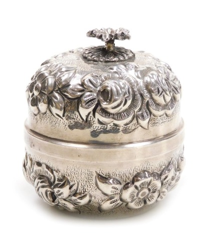 A Continental cylindrical box and cover, white metal, embossed with bands of flowers, with floral finial, stamped MA 700, 4.99oz, 9cm high.