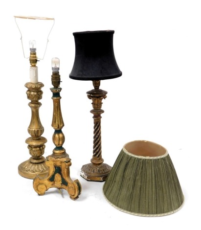 Three 19thC Continental gilt wood and painted candlesticks, converted to table lamps, 66cm, 52cm high respectively.