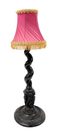 A late 19thC bronze table lamp, the spiral fluted column above a band of putti with floral garlands, over a circular base, 47cm high.