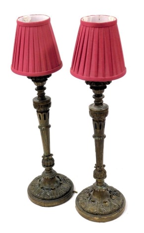 A pair of 19thC bronze effect wooden candlesticks, of leaf carved and fluted form, converted to table lamps, 61.5cm high.