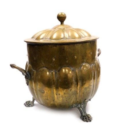 A 19thC brass coal bucket, of twin handled semi fluted form, with lid, raised on three paw feet, 43cm high.