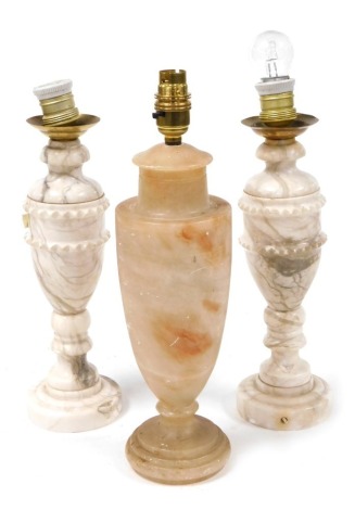 A pair of alabaster table lamps, of vase form, 35cm high, and a further alabaster table, of vase form, 47.5cm high. (3, AF)