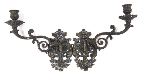 A pair of 19thC brass candle sconces, embossed with flowers and rococo scrolls, 21cm deep.