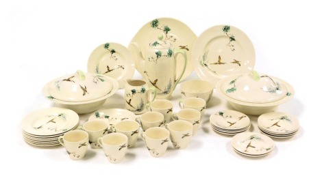 A Royal Doulton Coppice pattern part dinner and coffee service, comprising a pair of vegetable tureens and covers, coffee pot, cream jug, sugar bowl, bread plate, ten coffee cups and saucers, bread and cake plates, two tea saucers and eight tea plates.