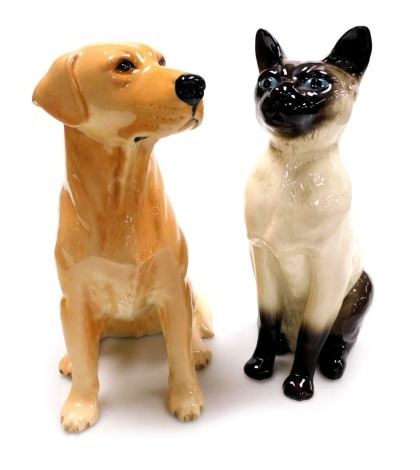 A Beswick fireside figure of a Labrador dog, 34cm high, and a Beswick fireside figure of a Siamese cat, 36cm high. (2)