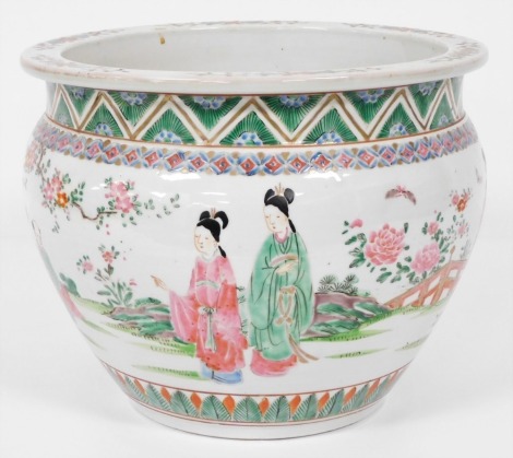 A 20thC Chinese famille rose porcelain jardiniere, decorated with figures in a garden setting, within foliate borders, 30cm wide.