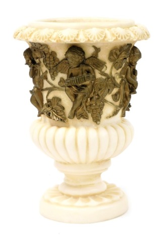 A late 20thC resin urn, of semi-fluted form, gilt decorated with a band of musical cherubs and vines, raised on a circular base, 40cm high.