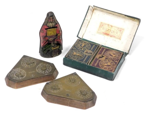 A Victorian royal game of Bezique by C Goodall & Son, London, boxed, together with a pair of wooden and brass mounted Bezique markers, and a Victorian tin money box, formed as a magician, "Magician Am I and Can Turn As Of Old, Your Copper to Silver, Your 