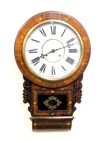 A late 19thC American rosewood cased drop dial wall clock, by The Waterbury Clock Company, circular dial bearing Roman numerals, eight day movement, the case with carved and inlaid decoration, 71cm high.