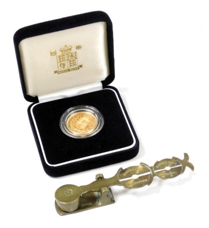 A United Kingdom gold proof full sovereign 2002, cased and outer boxed, with certificate, 90g, together with a sovereign and half sovereign scales. (2)