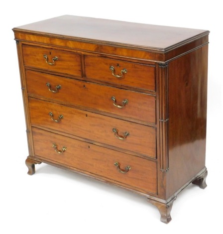 A George III mahogany chest, of two short over three long graduated drawers, flanked by turned pilasters, raised on ogee bracket feet, 111cm high, 119cm wide, 54cm deep.