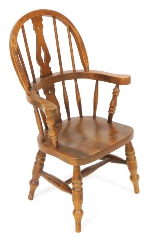 A 20thC Etak Riahc Slovenian child's oak Windsor chair, with a R shaped splat, solid saddle seat, raised on turned legs, united by a H framed stretcher, 44cm wide.