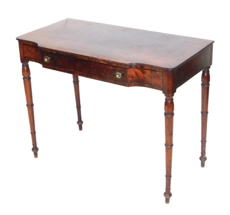 An early 19thC Continental flamed mahogany side table, with long shaped frieze drawer, raised on ring turned legs, 76cm high, 97cm wide, 49.5cm deep.