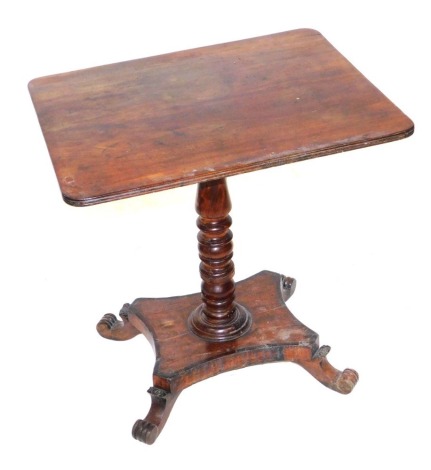 A George IV mahogany and rosewood crossbanded occasional table, the rectangular top above a turned column, over a quatrefoil base, on leaf capped scroll feet, 70cm high, 69cm wide, 56.5cm deep.