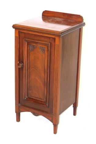 A Victorian walnut pot cupboard, with a carved door, raised on tapering square legs, 78cm high, 37cm wide, 37cm deep.