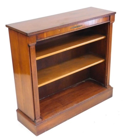 A Regency style yew wood open bookcase with two shelves, raised on a plinth base, 92cm high, 98cm wide, 33cm deep.