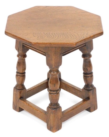 A 17thC style oak octagonal occasional table, raised on baluster turned columns united by a box stretcher, 41cm high, 38.5cm wide. Auctioneer Announce only one table in lot.