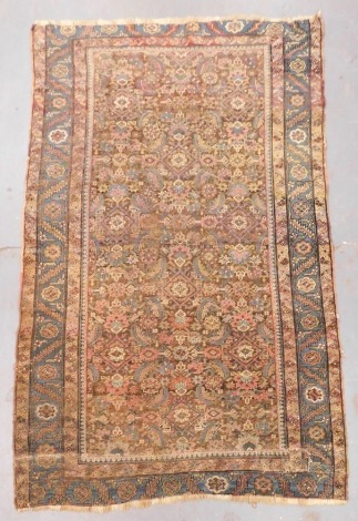 A Tabriz brown ground rug, the central field filled with flowers and leaves, within repeating floral borders, 240cm x 152cm.