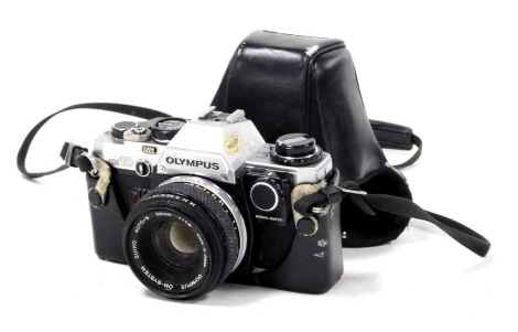 An Olympus OM10 camera, with a a Zuiko Auto-S 50mm lens, serial no. 1315650, cased.