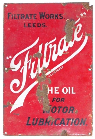 An enamel sign for Filtrate Works Leeds, The Oil for Motor Lubrication, single sided, black and white lettering against a red ground, 53cm x 35.5cm.