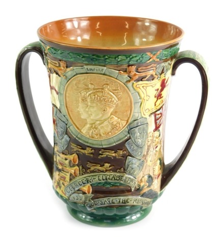 A Royal Doulton George VI Coronation loving cup designed by Charles Noke, with raised decoration cameo of King George and Queen Elizabeth, etc., decorated in poly chrome enamels, number 362/2000, inscribed to the base, 26.5cm high.