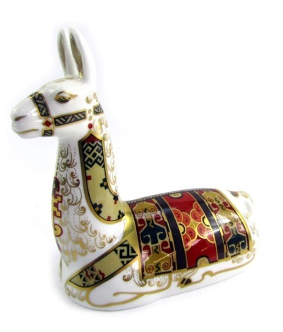 A Royal Crown Derby porcelain paperweight modelled as Llama, an exclusive to The Royal Crown Derby Collectors Guild, gold stopper and red printed marks, 13.5cm high.