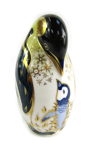 A Royal Crown Derby porcelain paperweight modelled as a penguin and chick, gold stopper and red printed marks, 13cm high, boxed.