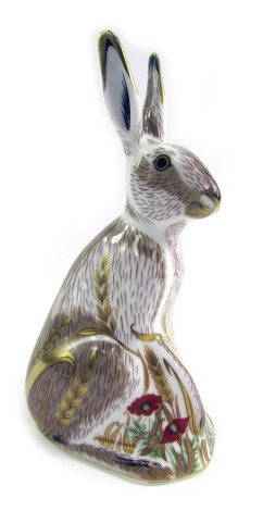 A Royal Crown Derby porcelain paperweight modelled as Mid-Summer Hare, gold stopper and red printed marks, 17cm high.