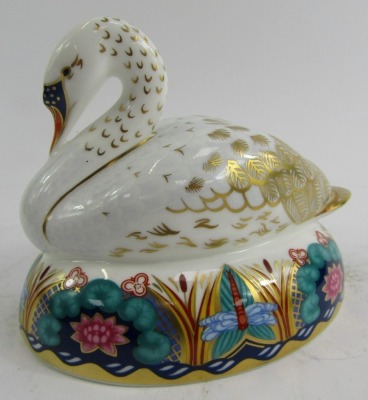 A Royal Crown Derby porcelain paperweight modelled as a swan, silver stopper and red printed marks, 11cm high. - 2