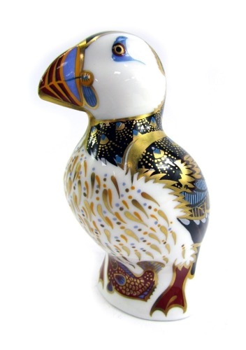 A Royal Crown Derby porcelain paperweight modelled as a puffin, silver stopper and red printed marks, 11.5cm high, boxed.