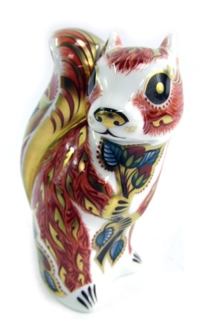 A Royal Crown Derby porcelain paperweight modelled as Woodland Squirrel, gold stopper and red printed marks, 11cm high, boxed.