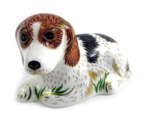 A Royal Crown Derby porcelain paperweight modelled as Belle, gold stopper and red printed marks, 5cm high, boxed.