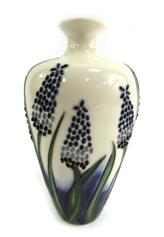 A Moorcroft bud vase, decorated with sprays of flowers in Sweetness pattern, signed to underside, 16cm high.