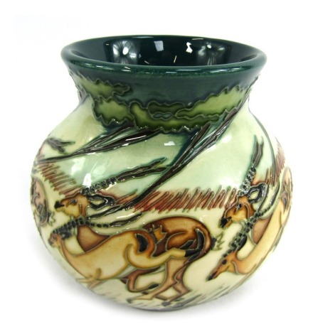 A Moorcroft Impala red vase, decorated to the ground with antelopes, stamped and dated to underside 2007, 12cm high.