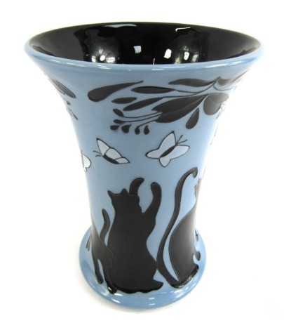 A Moorcroft vase, on a blue ground decorated with cats and butterflies, entitled Lucky Black Cat, designed by Paul Hilditch, stamped trial 1-10-14, 16cm high.