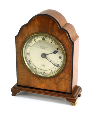 An early 20thC oak and walnut cased Elliott mantel clock, the silvered Roman numeric circular dial bearing name for J W Benson London, key wind, 18cm high.