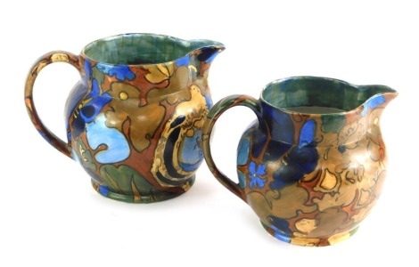 Two Bursley ware pottery jugs decorated in the Amstel pattern, 15cm high and 13.5cm high.