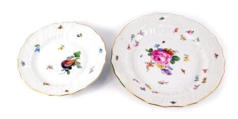 Two Meissen porcelain plates, painted centrally with flowers amongst beetles, printed marks, 24cm diameter, and fruit amongst flowers, printed marks, 20cm diameter, each with a gilt edge.