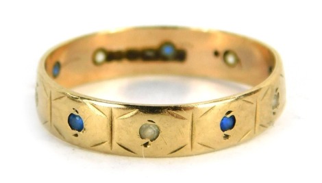 A sapphire and diamond eternity ring, set with round brilliant cut sapphire and diamonds, yellow metal, marked 9ct, ring size K, 1.2g all in.