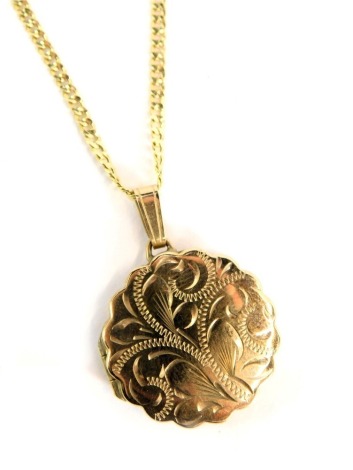 A 9ct gold locket pendant and chain, the circular locket with petalated border and engraved floral decoration, on a curb link neck chain, the pendant 2cm high, the chain 44cm long, 5g, boxed.