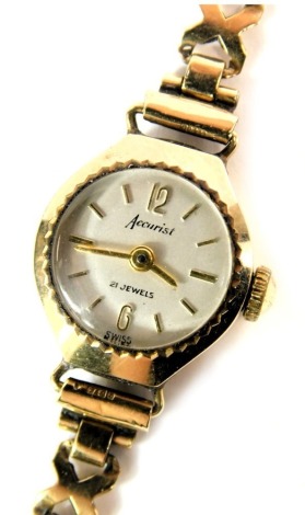 A 9ct gold Accurist lady's wristwatch, with a silvered circular dial, 1.5cm diameter, on crossover bracelet, 10.7g all in.