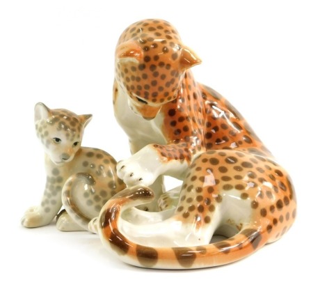 A Russian Lomonosov porcelain model of a seated leopard, 16.5cm high, and a model of a seated leopard cub, 10.5cm high.