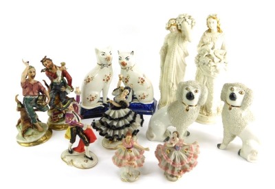 A group of 20thC Continental and other porcelain, to include Dresden crinoline figures, a pair of Capodimonte style figures, pair of Staffordshire cats, 19cm high, porcelain figures of classical ladies, etc. (1 tray).